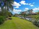 Backyard with waterfront view and lush landscaping at 221 Mclean Pt, Winter Haven, FL 33884