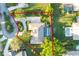 Aerial view of a property with a screened-in pool and lush landscaping, with the property line outlined in red at 2428 Wildwood Ct, Winter Haven, FL 33884
