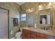 Double vanity bathroom with granite countertops and decorative wallpaper at 2428 Wildwood Ct, Winter Haven, FL 33884