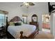 Main bedroom with king-size bed, ceiling fan, and ensuite bathroom at 2428 Wildwood Ct, Winter Haven, FL 33884