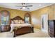 Elegant Primary bedroom with a large bed, dresser, and ensuite bathroom at 2428 Wildwood Ct, Winter Haven, FL 33884