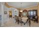 Bright dining room with large windows, a table for six, and a china cabinet at 2428 Wildwood Ct, Winter Haven, FL 33884