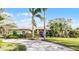 Beautiful single-story home with a well-maintained lawn, lush landscaping, and a circular driveway at 2428 Wildwood Ct, Winter Haven, FL 33884
