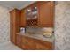Kitchen with wood cabinets, granite countertops, and a wine rack at 2428 Wildwood Ct, Winter Haven, FL 33884