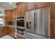 Modern kitchen featuring stainless steel appliances and ample wood cabinetry at 2428 Wildwood Ct, Winter Haven, FL 33884