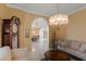 Living room with arched doorway to dining room, chandelier, and comfortable seating at 2428 Wildwood Ct, Winter Haven, FL 33884