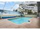Screened pool with tropical mural and blue tile at 2428 Wildwood Ct, Winter Haven, FL 33884