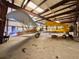 Hangar interior featuring two airplanes, including vintage biplanes, with ample space for aircraft maintenance at 25 Aviation Dr, Winter Haven, FL 33881