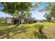 Backyard with patio and mature tree at 25 Aviation Dr, Winter Haven, FL 33881