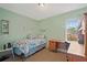 Bedroom with twin bed, desk and window at 25 Aviation Dr, Winter Haven, FL 33881