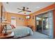 Bedroom with ceiling fan, window, and access to a patio at 25 Aviation Dr, Winter Haven, FL 33881