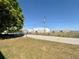 Open view showing hangar, perimeter fence, and entrance drive on a sunny day at 25 Aviation Dr, Winter Haven, FL 33881