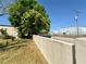 Perimeter wall along hangar with lush grass and green foliage under a clear blue sky at 25 Aviation Dr, Winter Haven, FL 33881