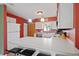 Bright kitchen with white cabinets, stainless steel appliances and breakfast bar at 25 Aviation Dr, Winter Haven, FL 33881