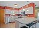 Galley style kitchen with white cabinets and breakfast bar at 25 Aviation Dr, Winter Haven, FL 33881