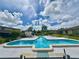 Community pool with lounge chairs and patio area at 25 Aviation Dr, Winter Haven, FL 33881
