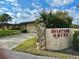 Aviation Drive entrance with lush landscaping, stone accents, and a view of the home at 25 Aviation Dr, Winter Haven, FL 33881