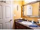 Bathroom with vanity, ornate mirror, and neutral color palette at 3001 Crystal Beach Rd, Winter Haven, FL 33880