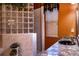 Bathroom with glass block shower, granite vanity, and window with blinds at 3001 Crystal Beach Rd, Winter Haven, FL 33880