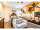 Bedroom with beach mural, comfortable seating and wood flooring at 3001 Crystal Beach Rd, Winter Haven, FL 33880