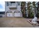 Two-car garage with driveway and lion statue at 3001 Crystal Beach Rd, Winter Haven, FL 33880