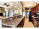 Modern kitchen with granite countertops and dark wood cabinets at 3001 Crystal Beach Rd, Winter Haven, FL 33880