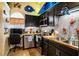Cozy kitchen with dark cabinetry and a beach theme at 3001 Crystal Beach Rd, Winter Haven, FL 33880