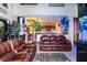 Spacious living room with brown leather couches and a view of the kitchen at 3001 Crystal Beach Rd, Winter Haven, FL 33880