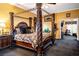Spacious main bedroom with a four-poster bed and ensuite access at 3001 Crystal Beach Rd, Winter Haven, FL 33880