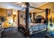 Elegant main bedroom with a four-poster bed and ensuite bath access at 3001 Crystal Beach Rd, Winter Haven, FL 33880