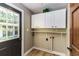 Laundry room with white cabinets and built in shelving at 3100 Peacock Ln, Mulberry, FL 33860