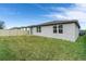 Backyard with grassy lawn, privacy fence, and sliding glass door at 3285 Weitzel Dr, Haines City, FL 33844