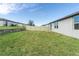 Backyard with grassy lawn, privacy fence, and stone wall at 3285 Weitzel Dr, Haines City, FL 33844
