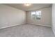 Bright bedroom featuring grey carpeting and a window at 3285 Weitzel Dr, Haines City, FL 33844