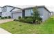 Gray house with gray garage door and landscaped front yard at 3285 Weitzel Dr, Haines City, FL 33844