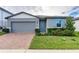Gray one-story house with gray garage door and blue front door at 3285 Weitzel Dr, Haines City, FL 33844