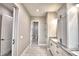 Hallway view to bathroom with white cabinetry and marble countertops for ample storage at 337 Doryman Way, Auburndale, FL 33823