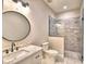 Bathroom featuring a vanity with marble countertop, framed round mirror and a walk-in shower with glass door at 337 Doryman Way, Auburndale, FL 33823