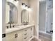 Bathroom with double vanity, marble countertop, and arched mirrors at 337 Doryman Way, Auburndale, FL 33823