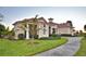 Beautiful front exterior with a paver driveway, manicured lawn and a red roof at 337 Doryman Way, Auburndale, FL 33823