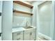 Laundry room with farmhouse sink, wooden shelves, and modern cabinetry at 337 Doryman Way, Auburndale, FL 33823