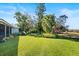 Landscaped backyard with lush greenery and palm trees at 38 Grenewood Ln, Haines City, FL 33844