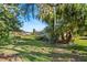 Spacious backyard with lush landscaping and mature trees at 38 Grenewood Ln, Haines City, FL 33844