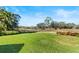 Large grassy backyard with tranquil view of nature at 38 Grenewood Ln, Haines City, FL 33844