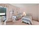 Two twin beds in a bright bedroom with wicker furniture and garden view at 38 Grenewood Ln, Haines City, FL 33844