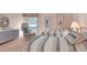 Bedroom with two twin beds, dresser, and wicker chair at 38 Grenewood Ln, Haines City, FL 33844