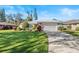 Single-story home with attached garage and lush landscaping at 38 Grenewood Ln, Haines City, FL 33844