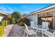 Brick patio with a table and chairs, surrounded by greenery at 38 Grenewood Ln, Haines City, FL 33844