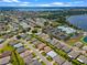 Aerial view of community with lake, homes, and clubhouse at 4068 Carteret Dr, Winter Haven, FL 33884