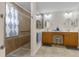 Elegant bathroom featuring double sinks, walk-in shower, and ample storage at 4068 Carteret Dr, Winter Haven, FL 33884